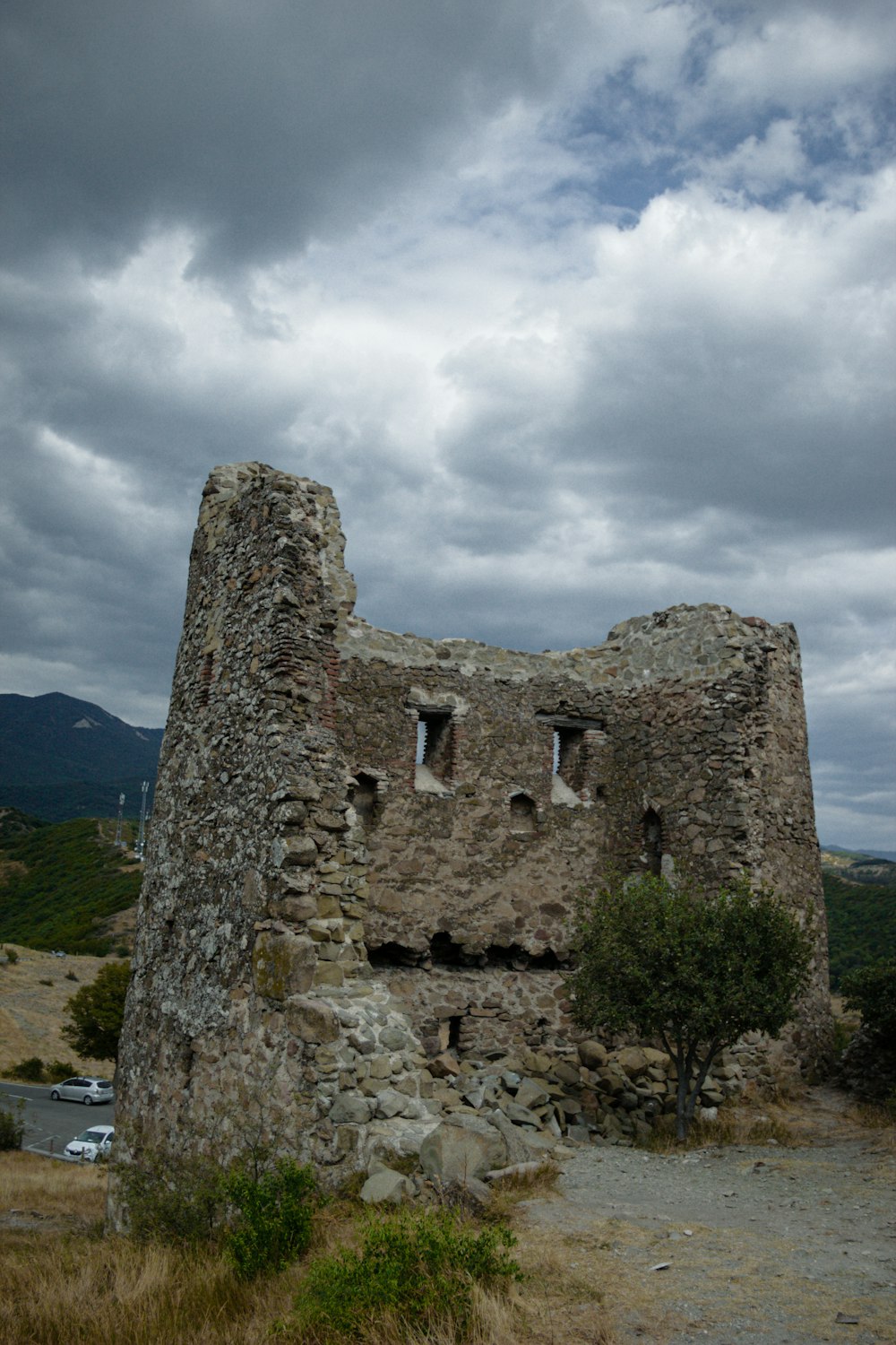 a stone building with a tree in front of it