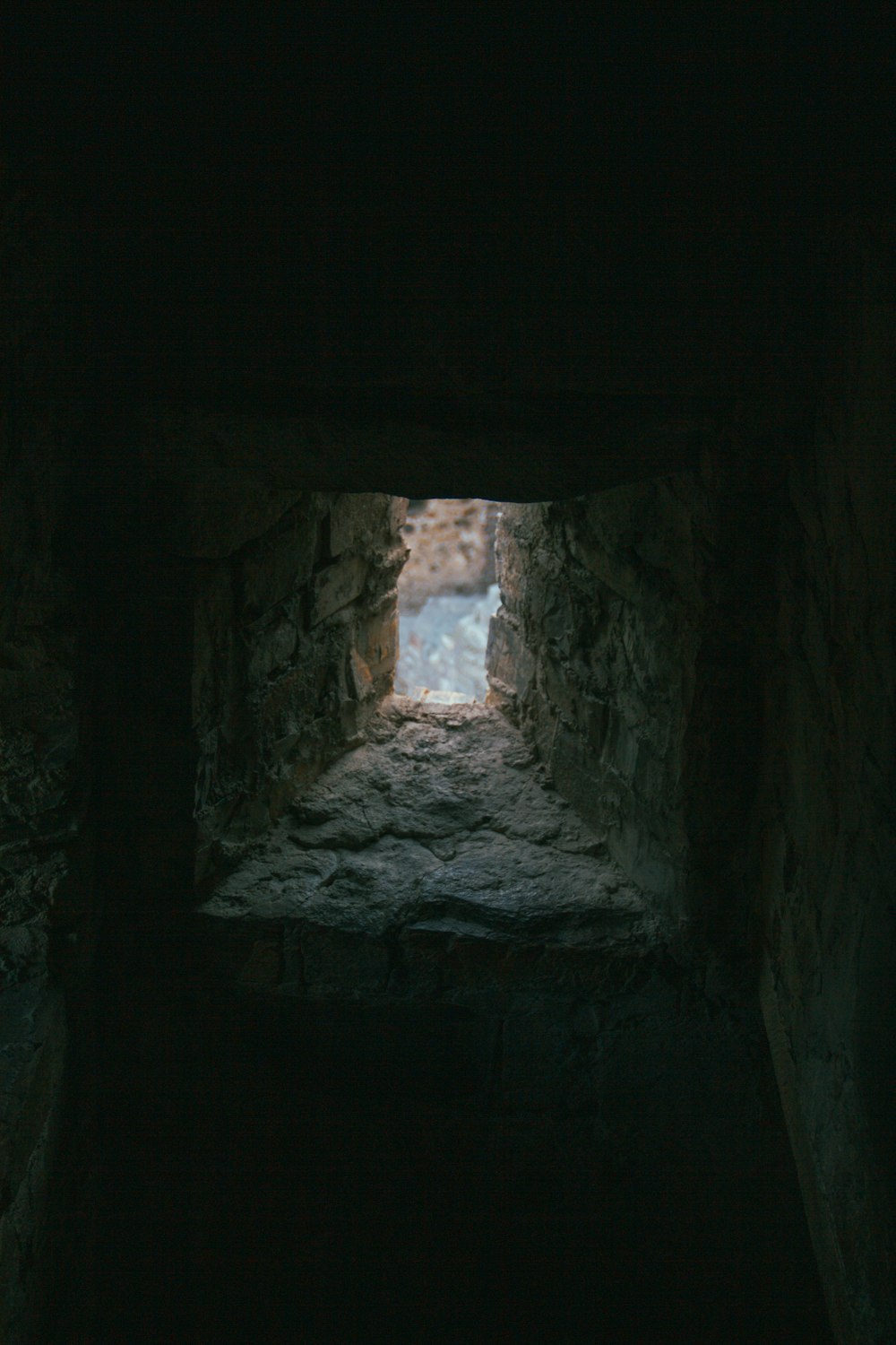 a stone wall with a hole in it