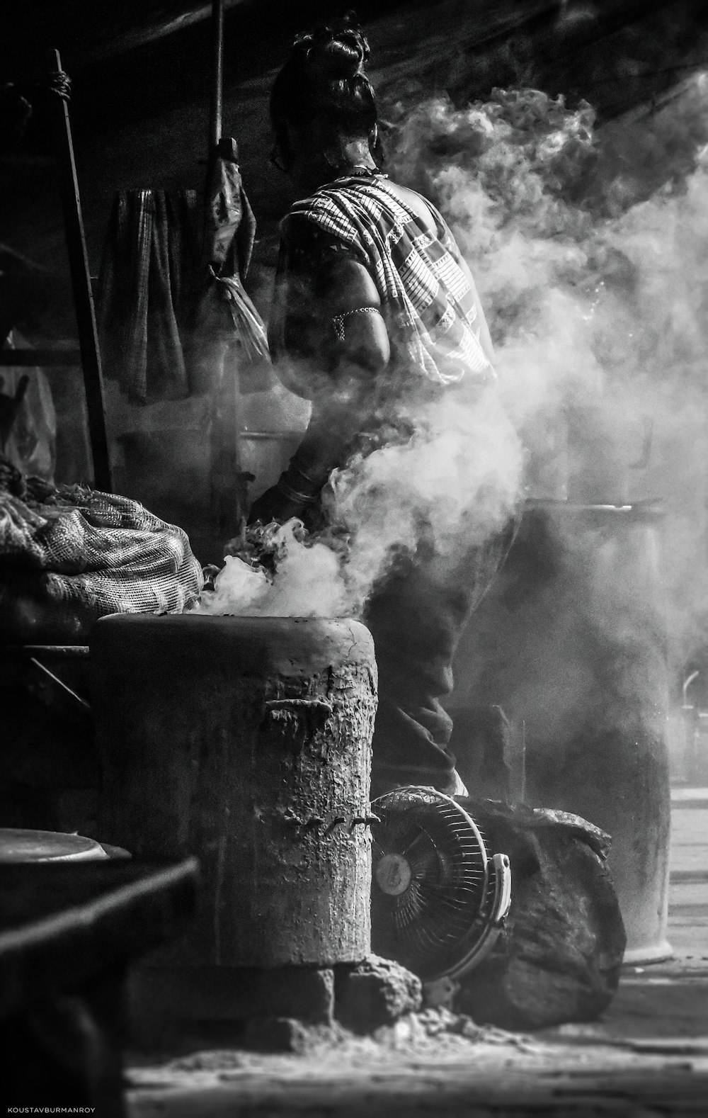 a person pouring water into a bucket