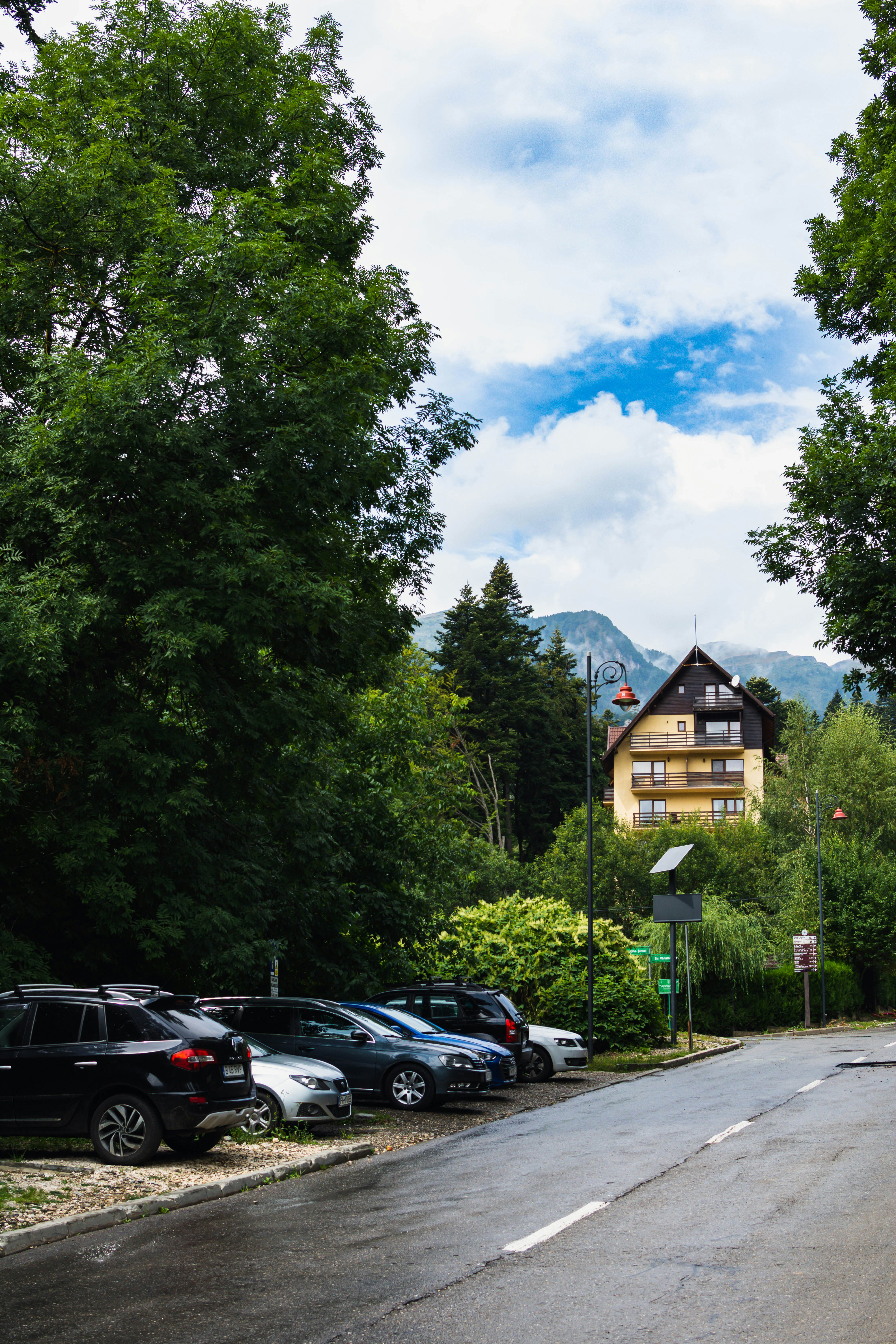 a parking lot with cars and trees