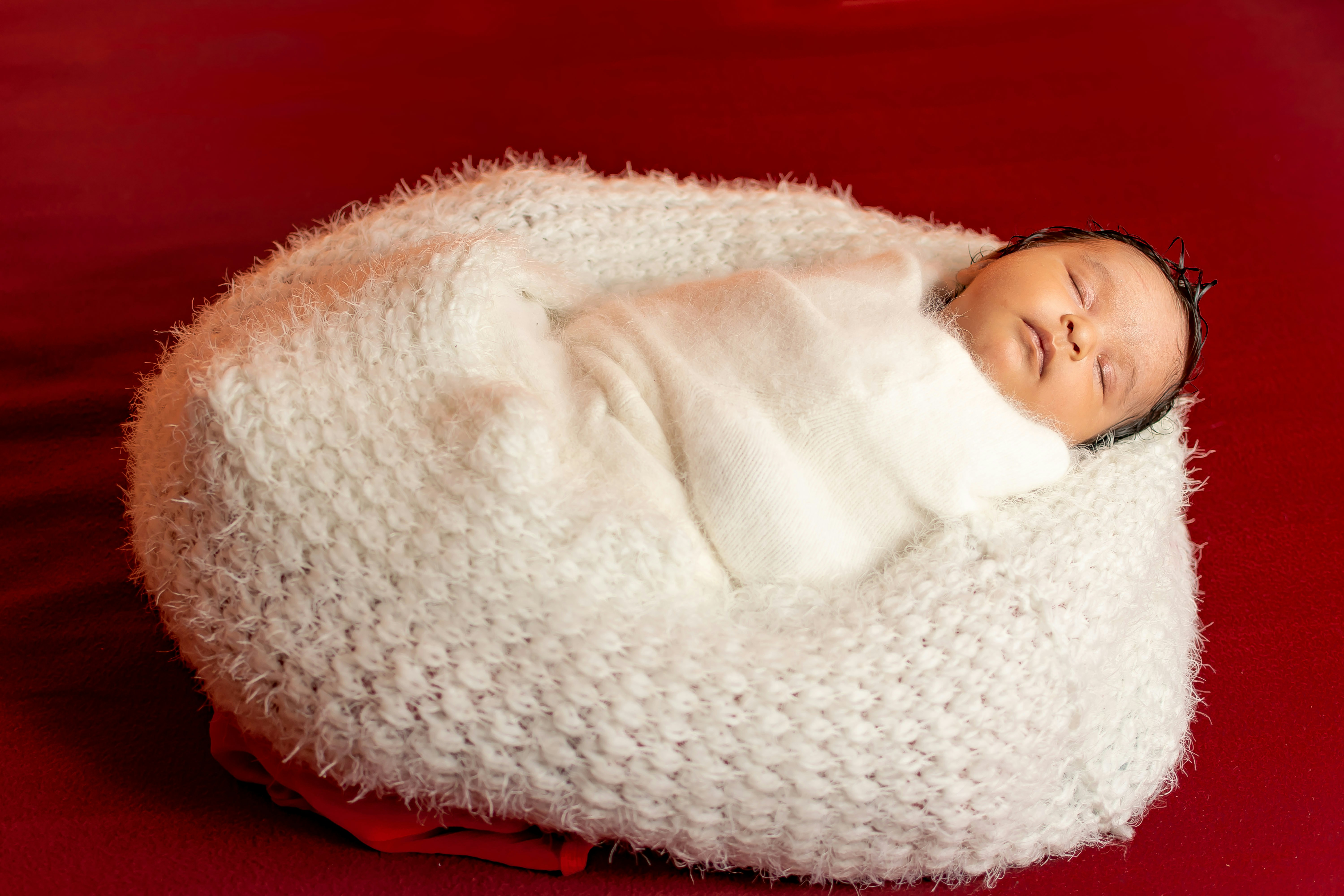 baby snuggled in a thicker fleece swaddle - organic swaddle blankets made in usa