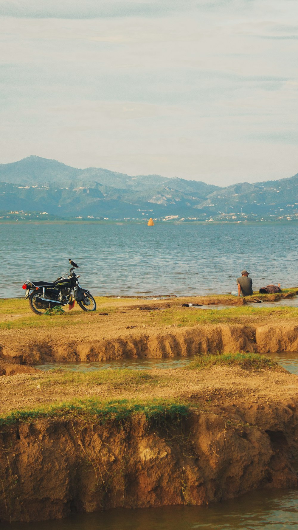 a man standing next to a motorcycle