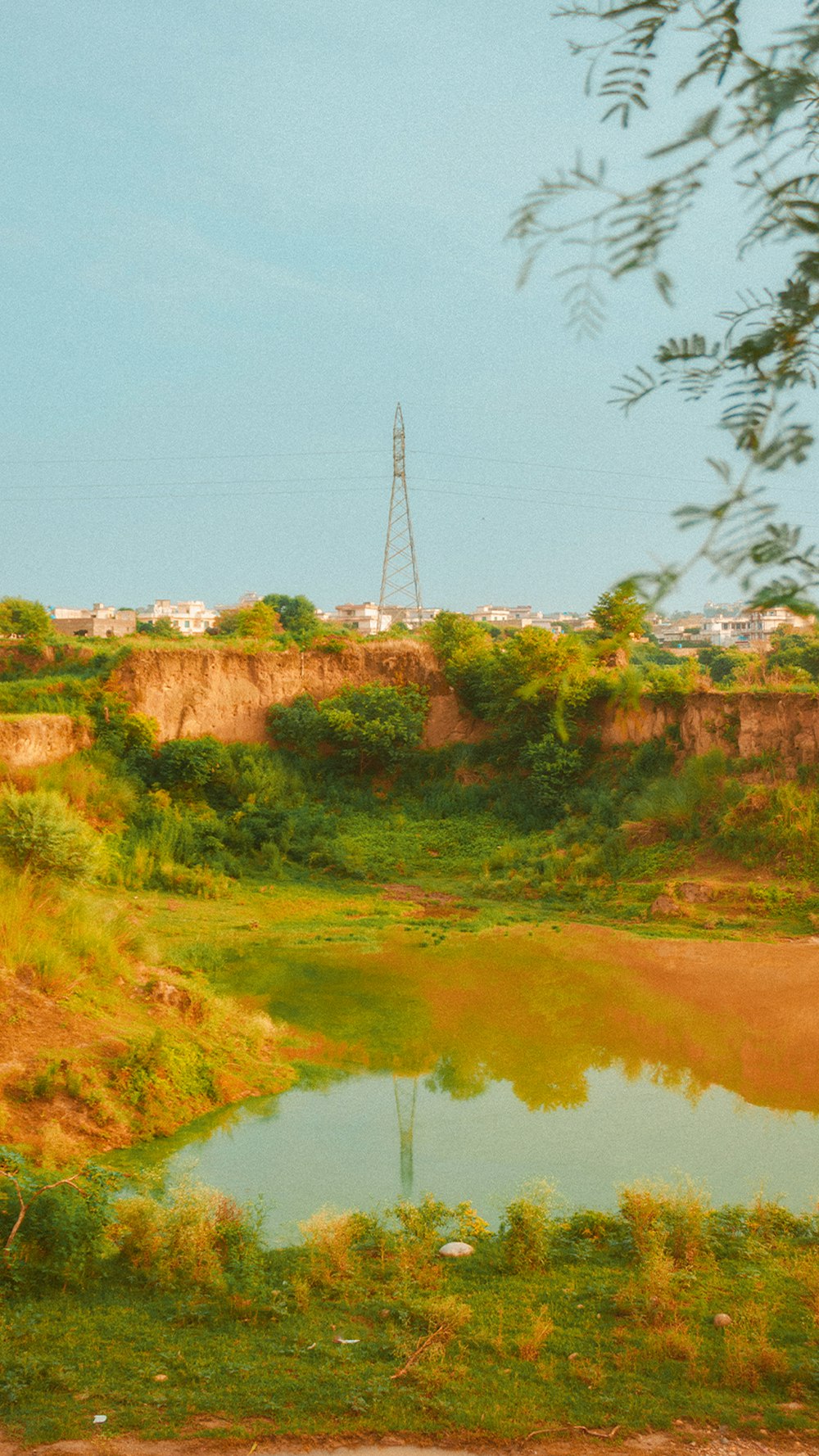 a body of water with trees and a tower in the background