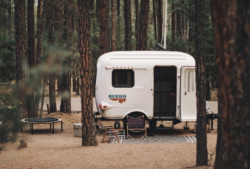 a camper parked in the woods