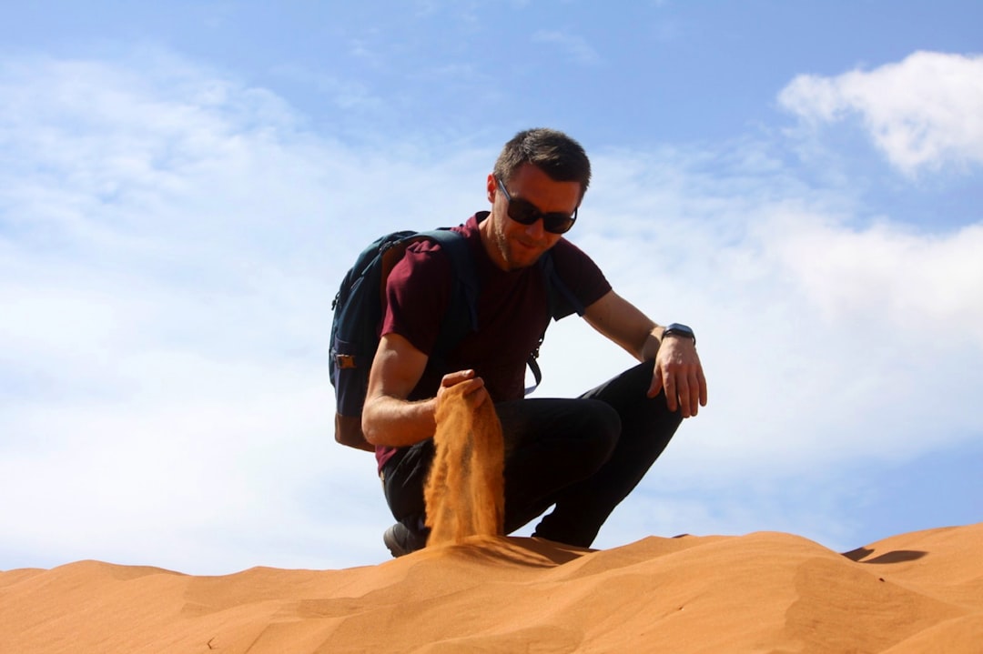 a man sitting on a rock, Moroccan Desert