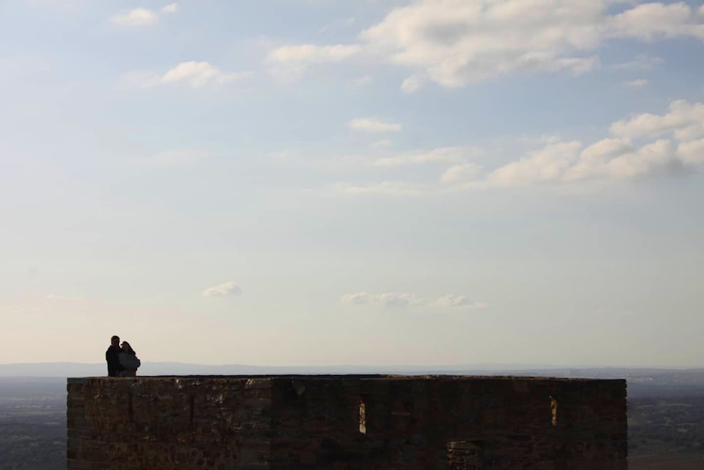 a person sitting on a wall