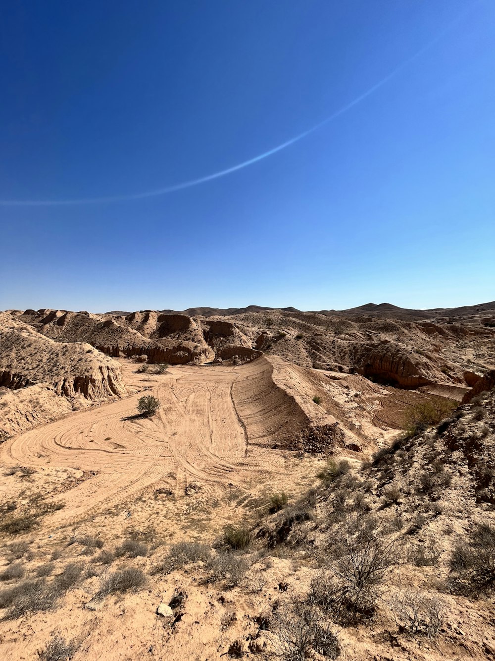 a desert landscape with a blue sky