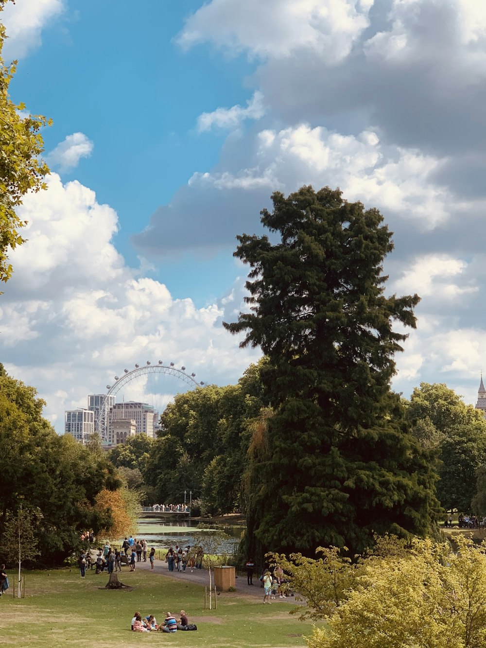 a park with a river and people