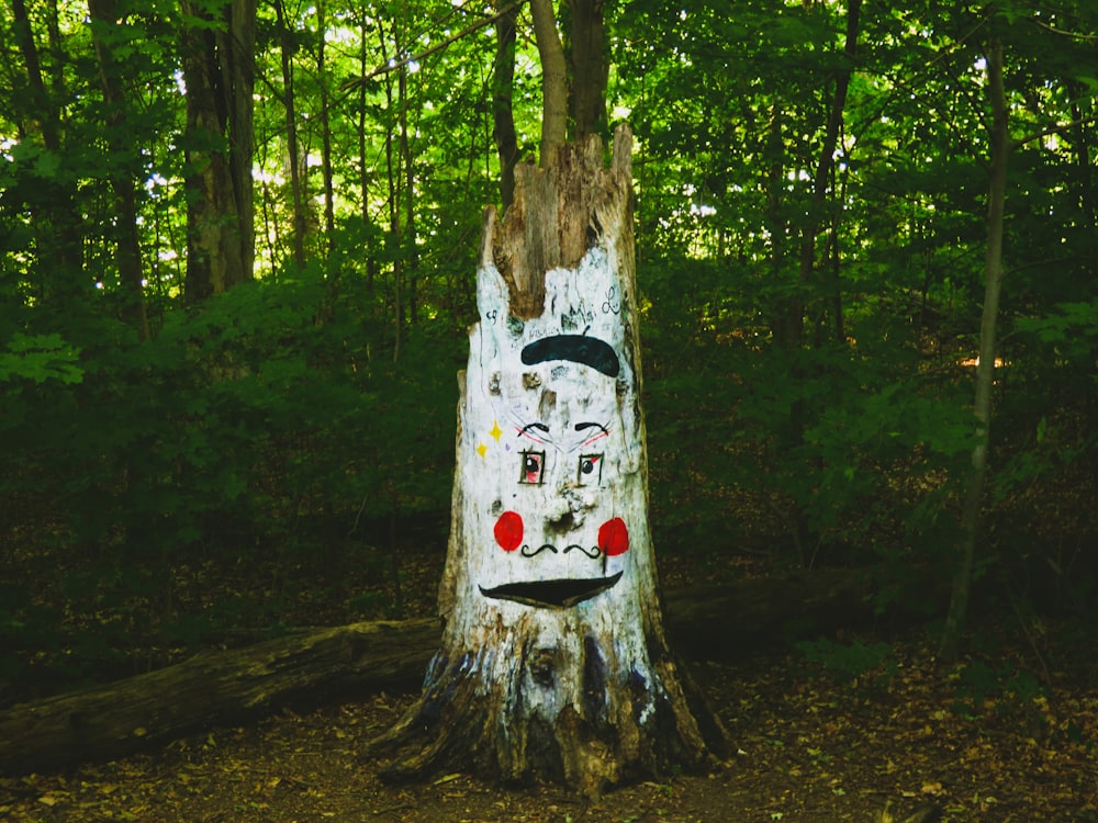 a tree with a face painted on it