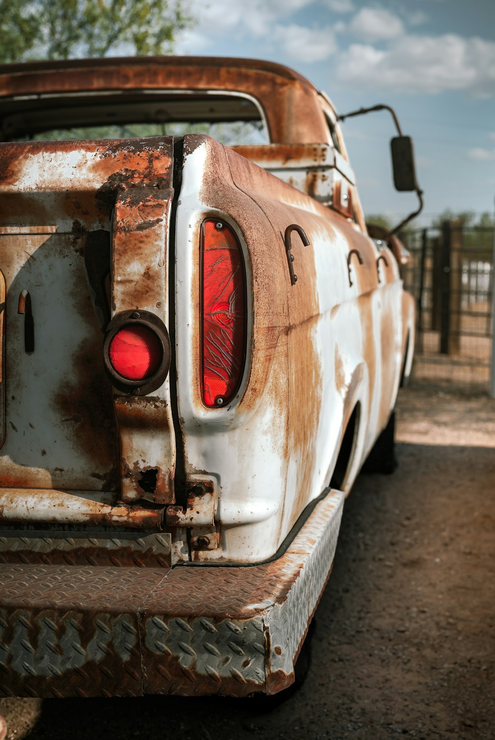 a rusted out car with a red light on the back