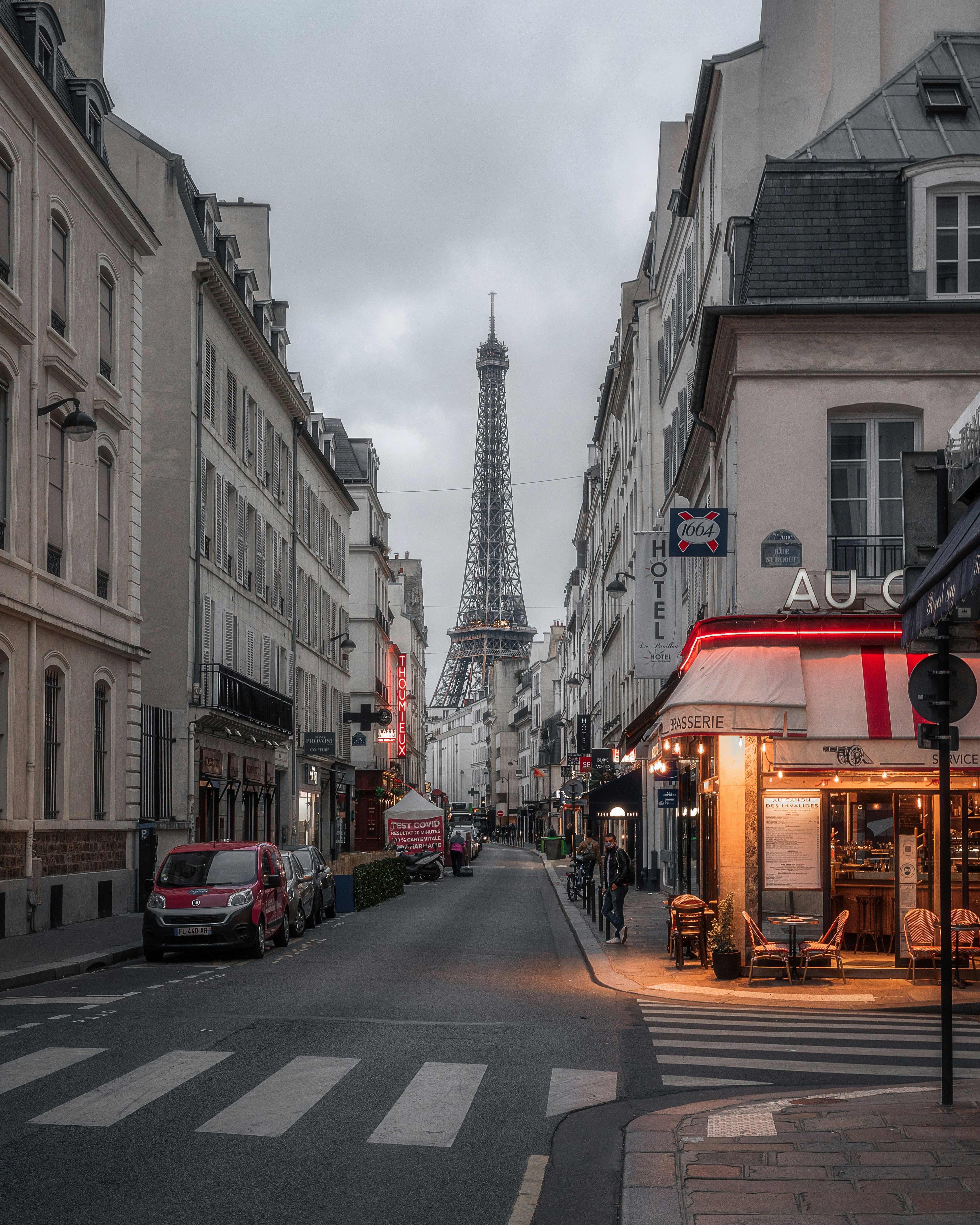a city street with buildings and a tower in the distance