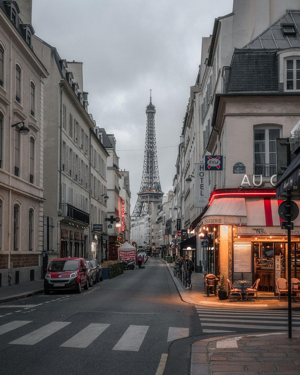 a city street with buildings and a tower in the distance