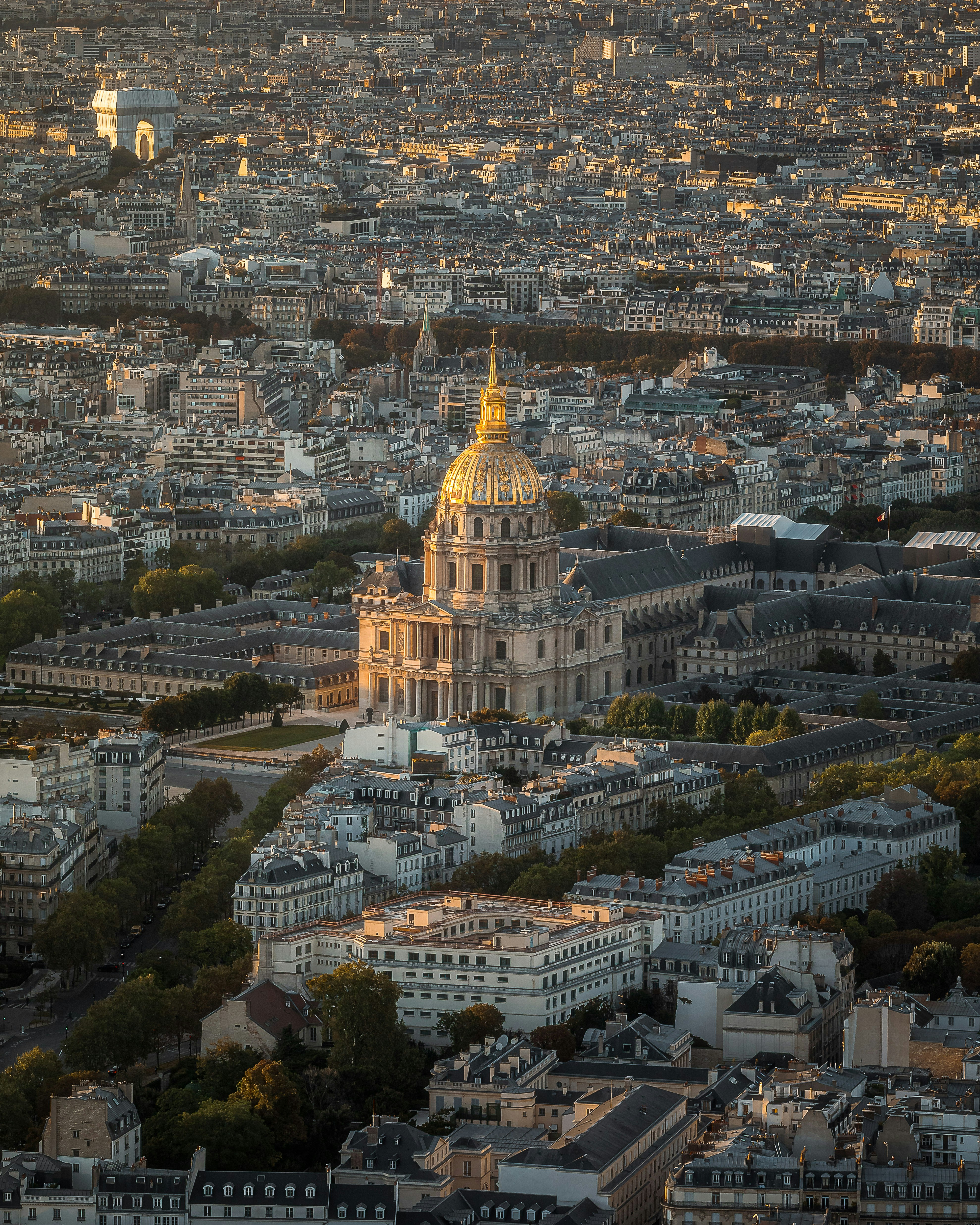 a large building with a gold domed roof surrounded by buildings