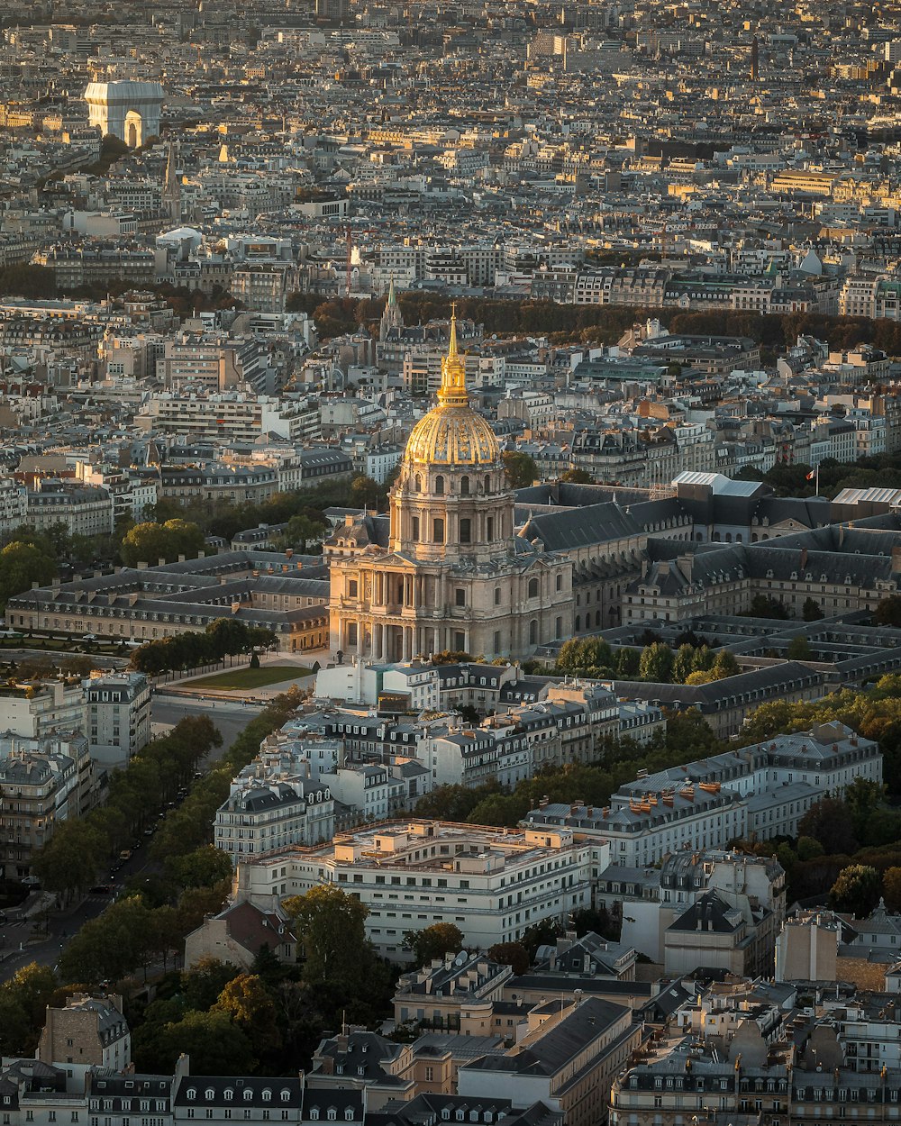 a large building with a gold domed roof surrounded by buildings