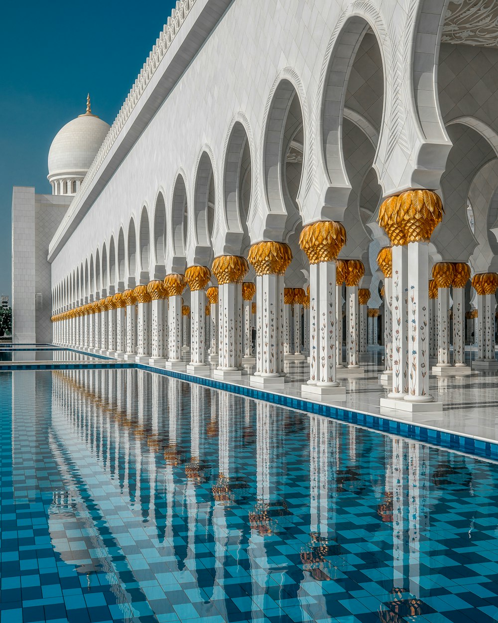 a large white building with a pool