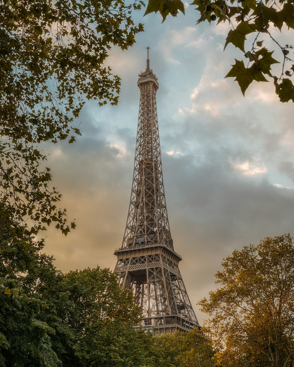 a tall metal tower with Eiffel Tower in the background