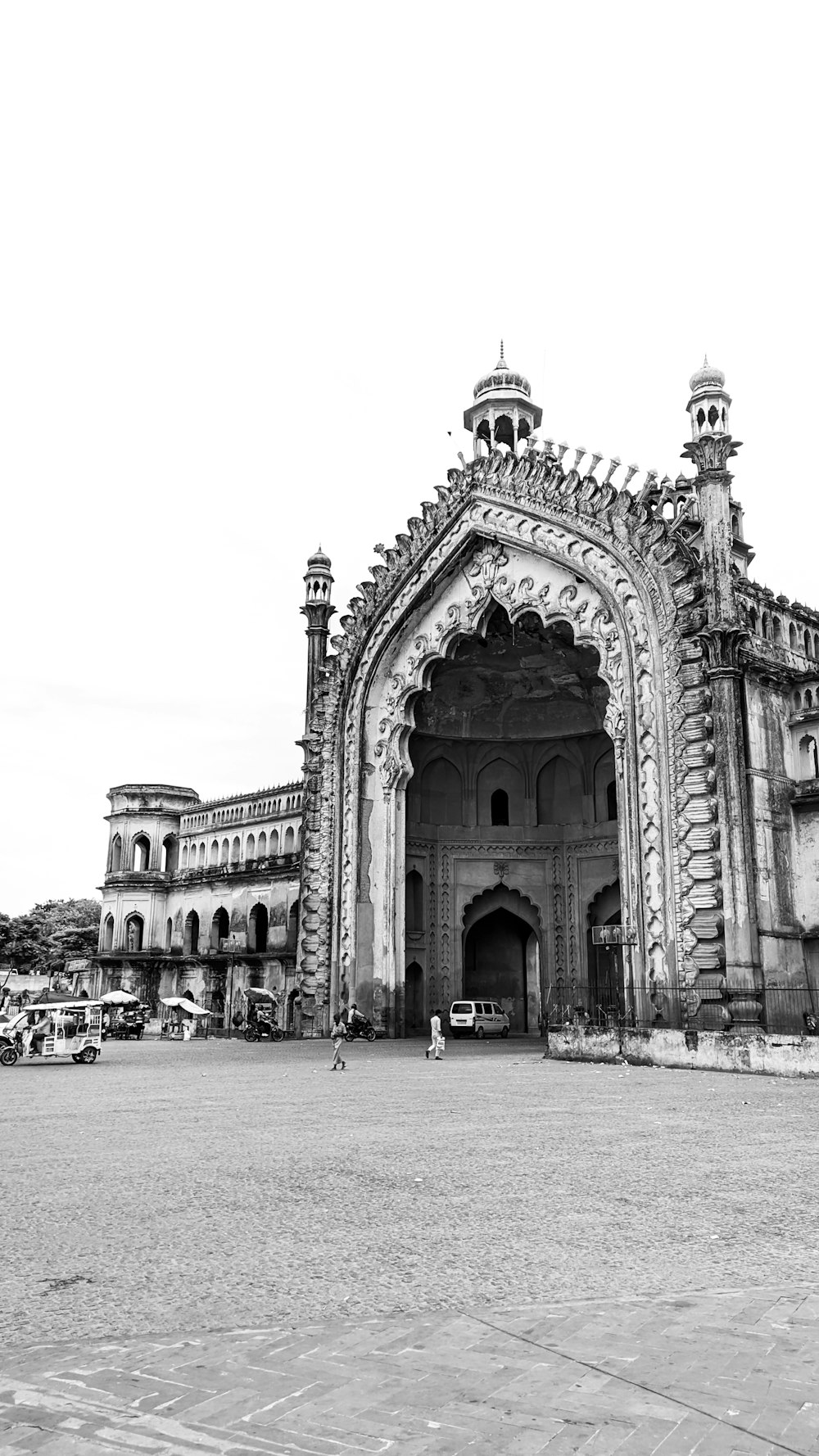 a large stone archway with a building in the background