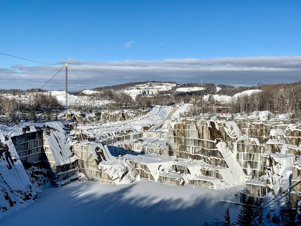 a snowy landscape with buildings and trees