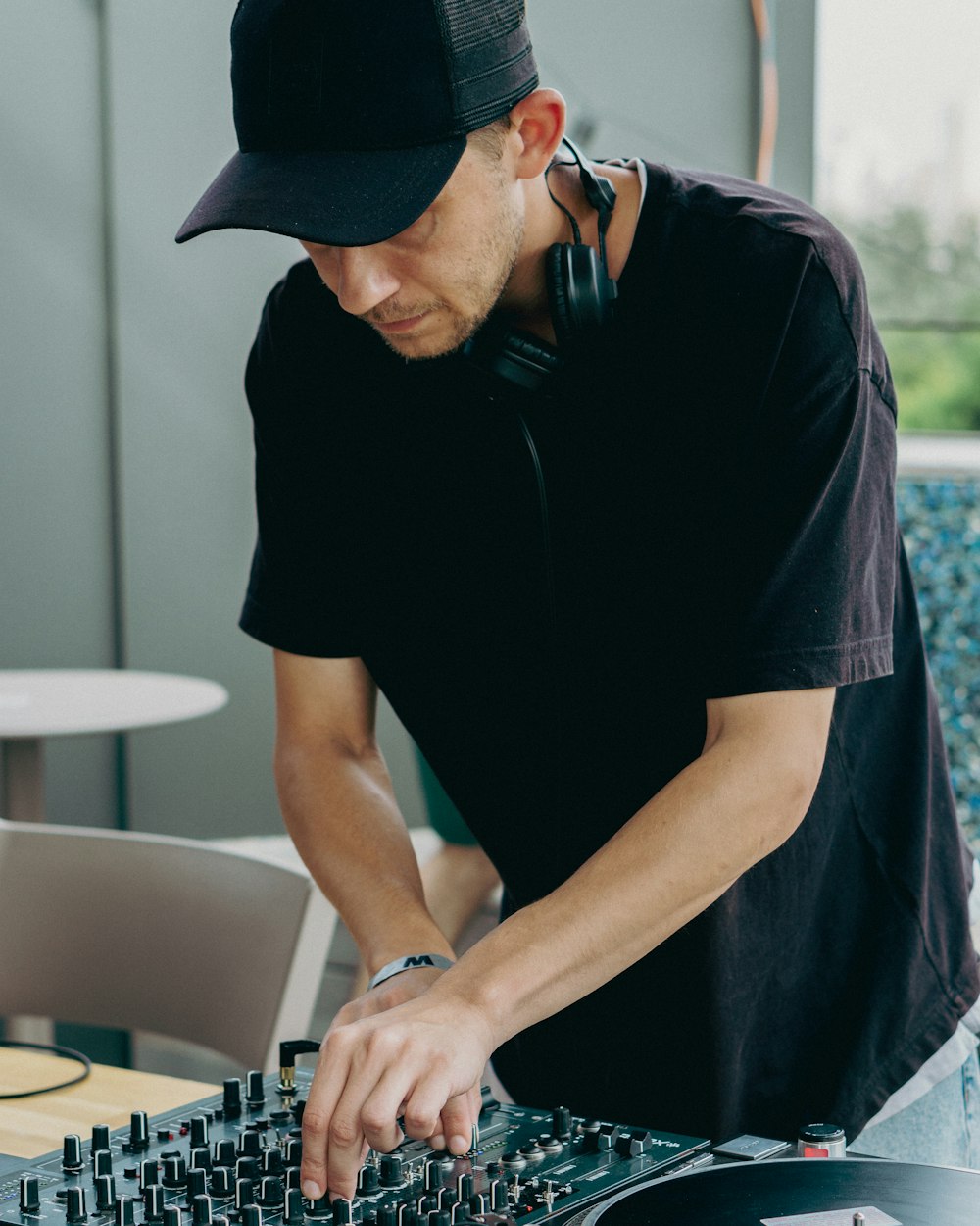 a man wearing a hat and headphones playing a music instrument