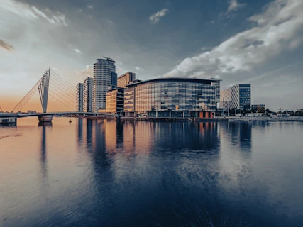 a bridge over water with buildings in the background