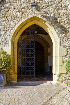 Close-up of a welcoming entrance gate with natural stone and wooden details in terracotta tones.