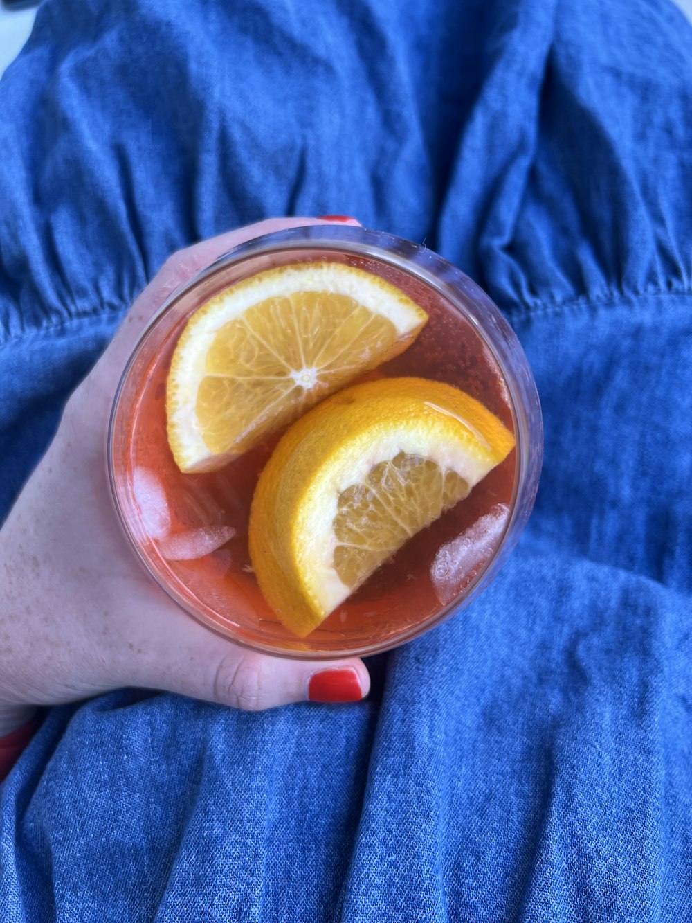 a person holding a half of an orange