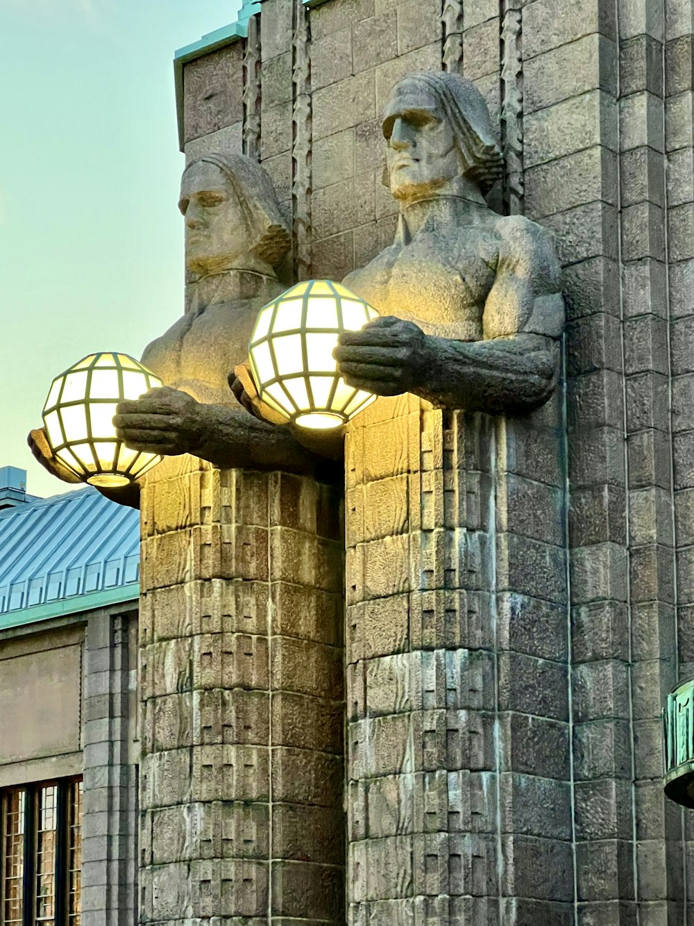 a statue of a person holding a light bulb
