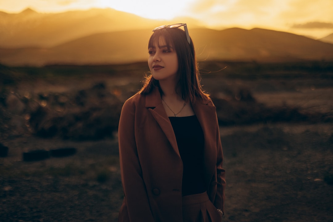 a woman standing in a field,