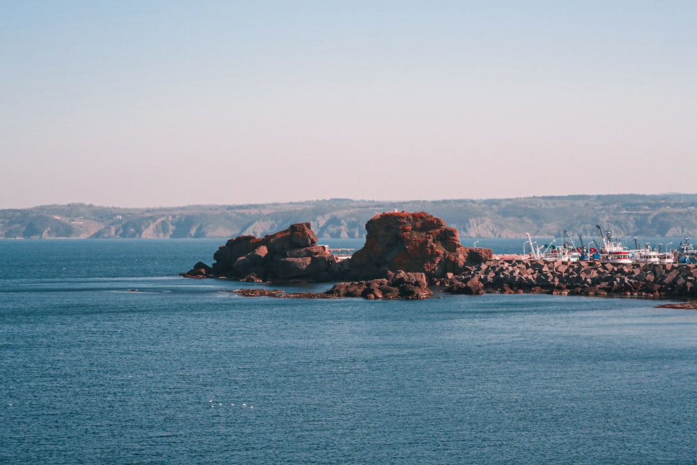 a rocky island with boats