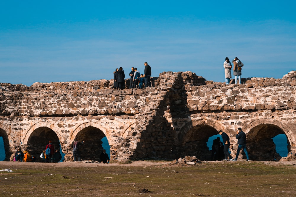 a group of people standing on a stone structure