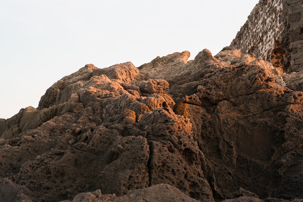 a rocky mountain with a blue sky