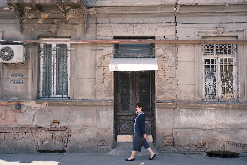 a man walking in front of a building