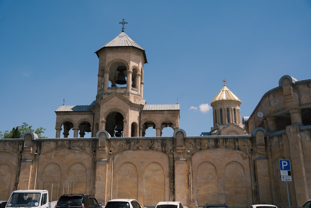 a large stone building with a large tower and a cross on top