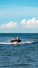 Speedboat cruising on clear blue sea with happy passengers