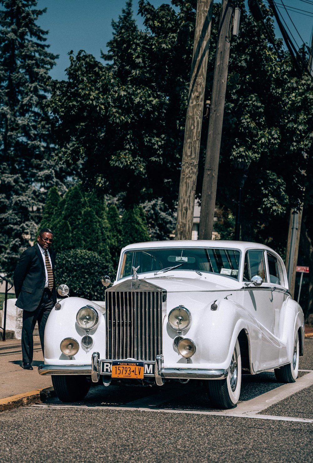 a person standing next to a white car