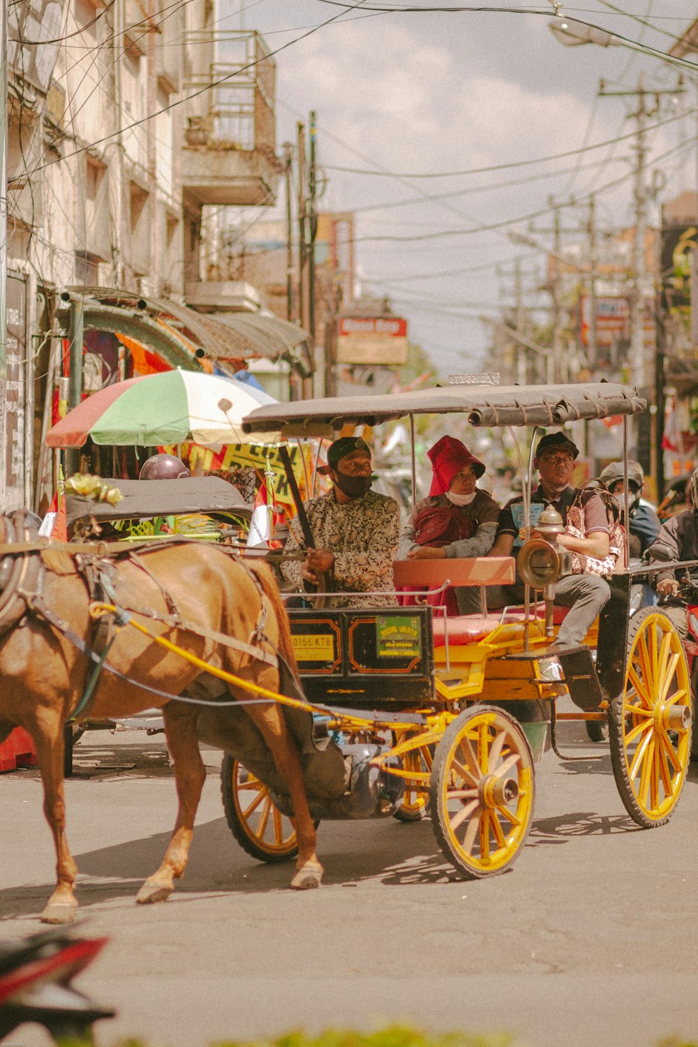 a horse pulling a cart with people in it