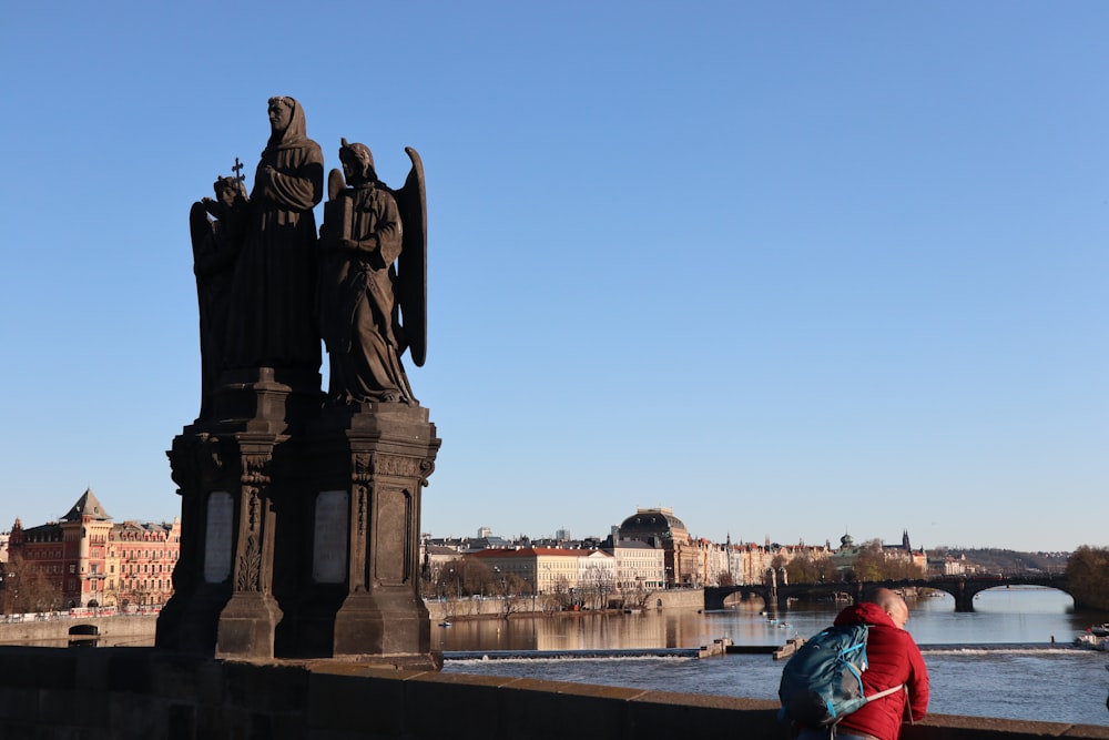 a group of statues by a river