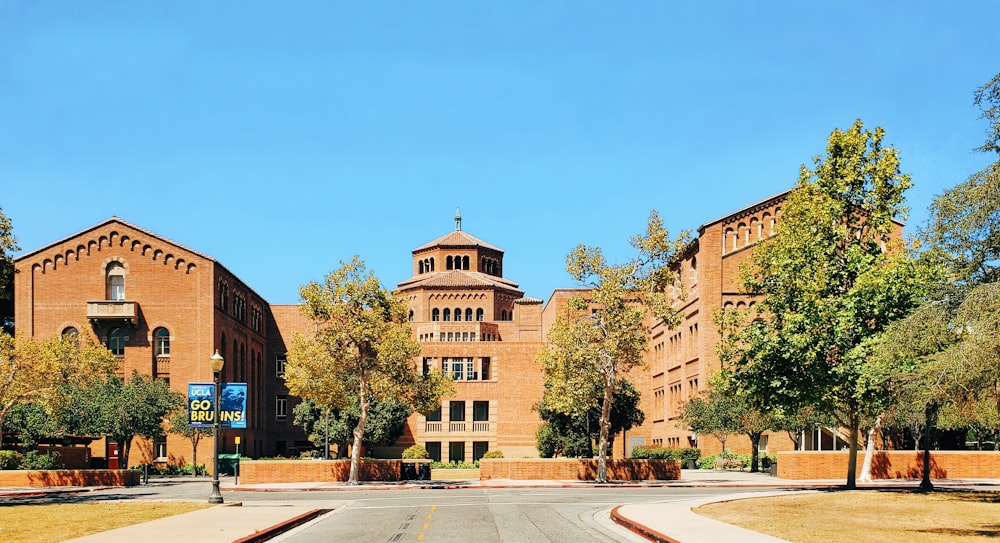 a large brick building with trees in front of it