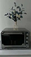Elegant black microwave oven placed on a clean kitchen countertop.