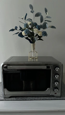 Elegant black microwave oven placed on a clean kitchen countertop.