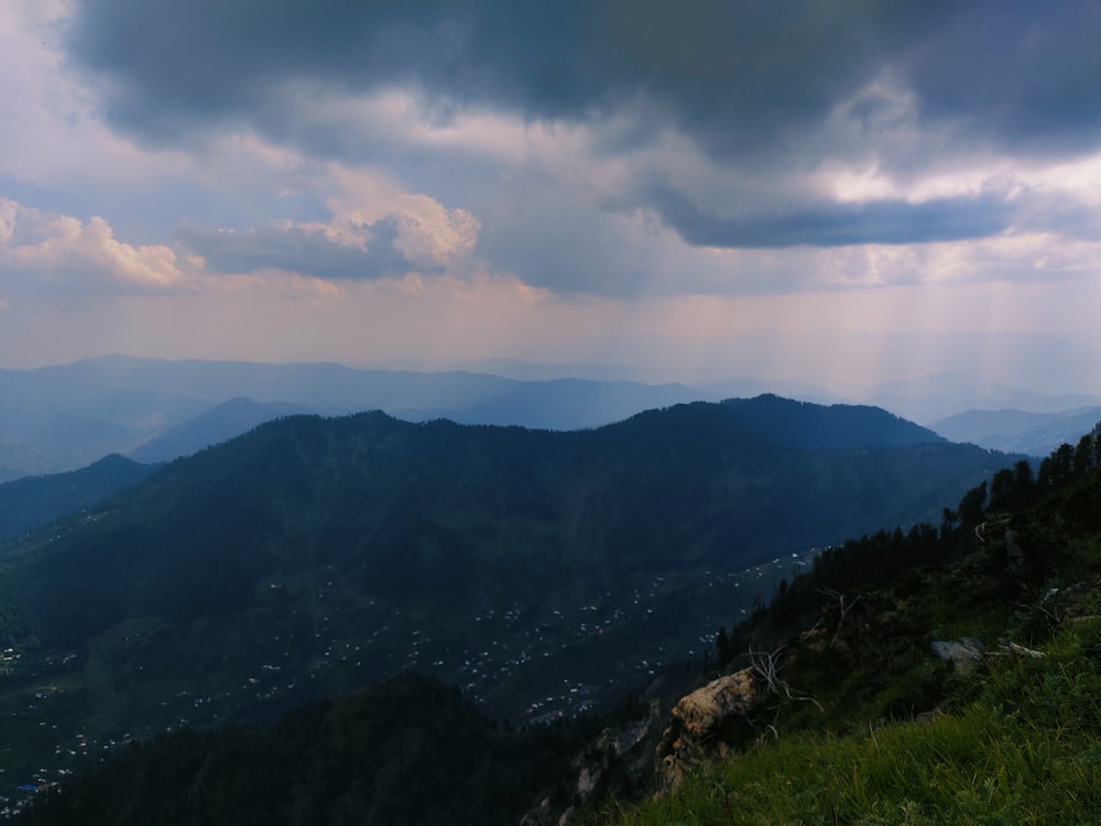 a landscape with mountains and clouds