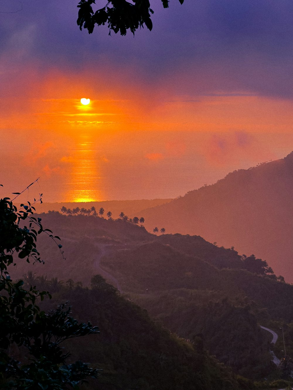 a sunset over a mountain