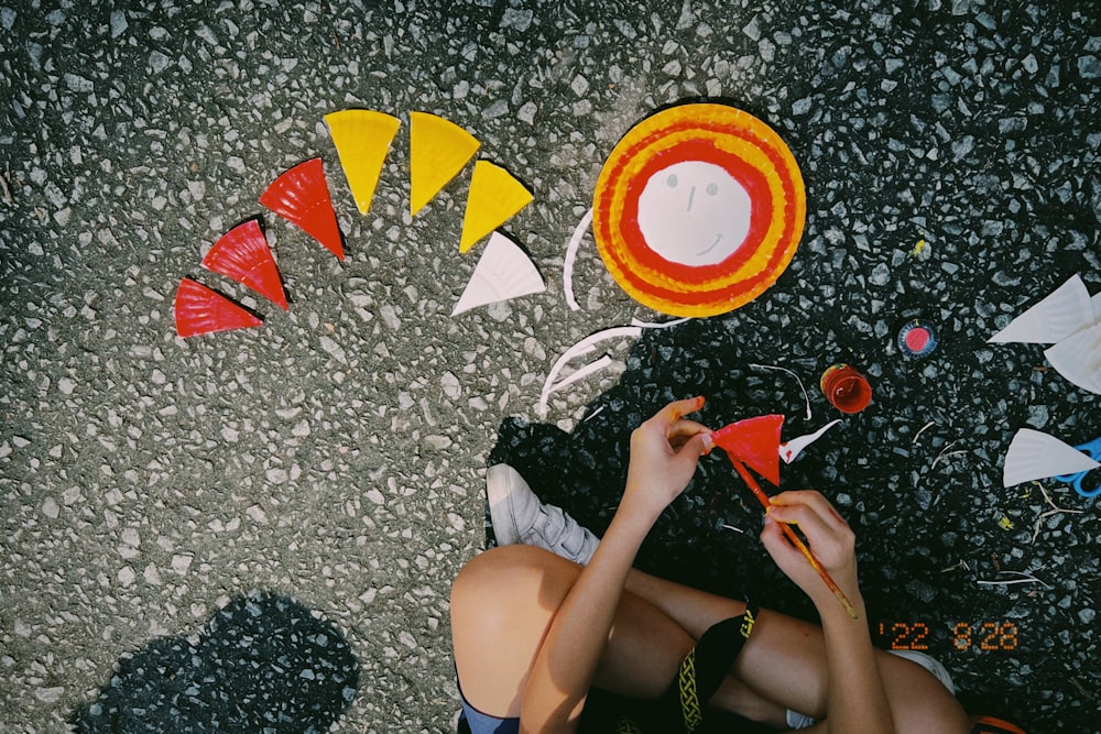 a woman lying on the ground with kites flying in the air