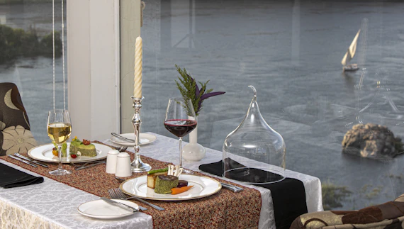 a table with plates and glasses of wine on it