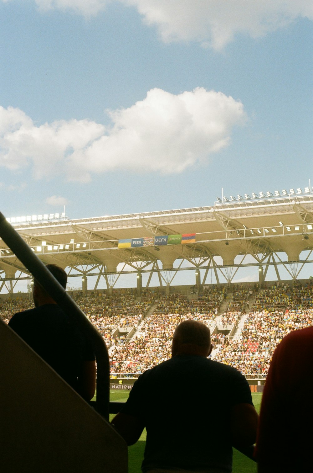 a stadium with a field and a crowd of people