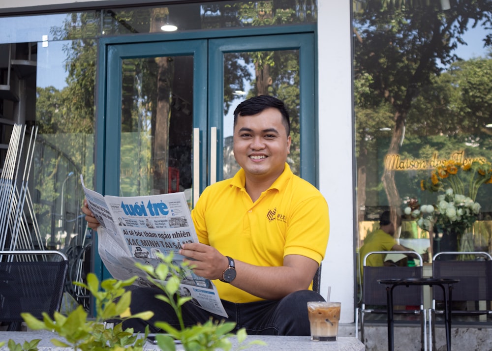 a man holding a newspaper