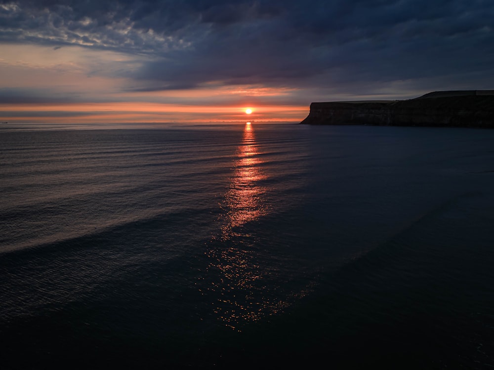 a sunset over a body of water