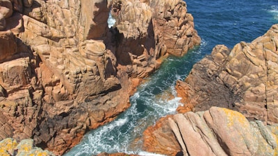 a rocky shoreline with a body of water in the background