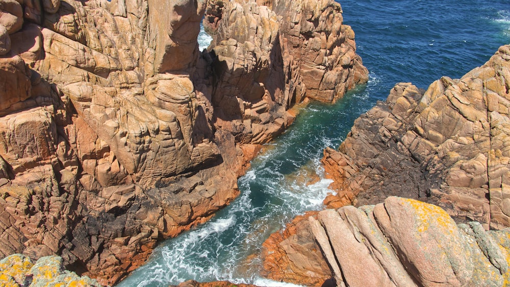 a rocky shoreline with a body of water in the background