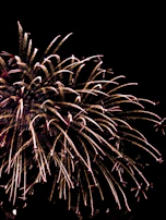 Aerial view of a fireworks display forming intricate patterns against the night sky.